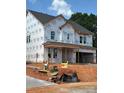 New two-story home shows Tyvek HomeWrap, windows installed, and the garage ready for doors at 177 Glenn Dr, Mooresville, NC 28115