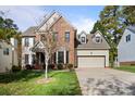 Beautiful two-story home with brick and siding, offering a well-manicured lawn and attached two-car garage at 19933 Scanmar Ln, Cornelius, NC 28031