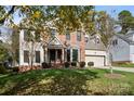 Inviting two-story brick-front home with a well-kept lawn, showcasing an attached two-car garage at 19933 Scanmar Ln, Cornelius, NC 28031