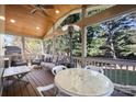 Relaxing screened porch with a wood ceiling, cozy seating, dining table, and view of the backyard at 19933 Scanmar Ln, Cornelius, NC 28031