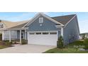 View of two-car garage and concrete driveway of charming single-Gathering home at 25966 Appleyard Ct # 1205, Lancaster, SC 29720