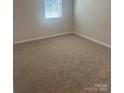 Bright bedroom with neutral carpeting and ample natural light at 2616 Tillman St, Monroe, NC 28112