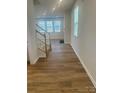 Inviting entryway featuring wood floors and staircase leading to the second floor at 2616 Tillman St, Monroe, NC 28112