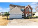 Attractive home featuring a brick and vinyl facade, double garage, and a well-kept front lawn at 279 Age Old Way, Rock Hill, SC 29732