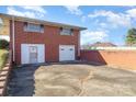 Brick two car garage plus door for entering; spacious parking area on a sunny day at 290 S Enochville Ave, Kannapolis, NC 28081