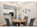 Charming dining area with a round table, upholstered chairs, and modern chandelier for cozy meals at 2941 Bellasera Way, Matthews, NC 28105