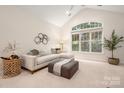 Comfortable living area with sectional sofa, large window, and vaulted ceiling, perfect for relaxing at 2941 Bellasera Way, Matthews, NC 28105
