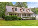 Inviting one-story home with dormers,a charming front porch with ramp,lush greenery, and manicured lawn at 3039 Paraham S Rd, York, SC 29745