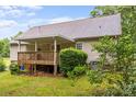 Backyard showcasing a wooden deck with awning, landscaped yard at 3039 Paraham S Rd, York, SC 29745