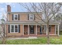 Traditional two-story home featuring a cozy front porch and classic architectural details at 307 Matthews Crossing Dr, Matthews, NC 28105