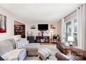 Comfortable living room with a plush sofa, large window, and a view into the dining room at 307 Matthews Crossing Dr, Matthews, NC 28105