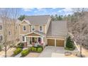 Charming two-story home featuring a welcoming front porch, manicured lawn, and a two-car garage at 3439 Richards Xing, Fort Mill, SC 29708