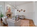 Stylish living room with fireplace, decorative chandelier, and neutral color palette at 4336 Tottenham Rd, Charlotte, NC 28226
