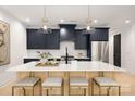 Modern kitchen with navy cabinets, quartz countertops, stainless steel appliances, and pendant lighting at 503 Norris Ave, Charlotte, NC 28206