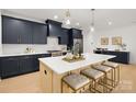 Modern kitchen with navy cabinets, quartz countertops, stainless steel appliances, and pendant lighting at 503 Norris Ave, Charlotte, NC 28206