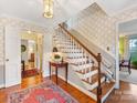 Wide view of the foyer featuring a hardwood staircase and access to other rooms at 555 Manning Dr # 7, Charlotte, NC 28209