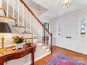Traditional foyer with hardwood floors, patterned wallpaper, and staircase at 555 Manning Dr # 7, Charlotte, NC 28209