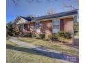 Charming brick home with manicured lawn and walkway leading to the front door at 7526 Dorn Cir, Charlotte, NC 28212