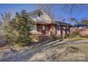 Charming brick home with manicured lawn and walkway leading to the front door at 7526 Dorn Cir, Charlotte, NC 28212