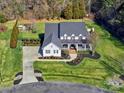 Expansive aerial view of a home with large manicured lawn, mature trees, and a circular driveway at 8817 Kerns Meadow Ln, Huntersville, NC 28078
