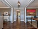 Elegant hallway with hardwood floors, decorative columns, and sophisticated decor at 8817 Kerns Meadow Ln, Huntersville, NC 28078
