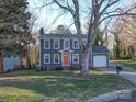Two-story home with gray siding, bright front door, attached garage, mature trees, and well-maintained lawn at 10929 Lassen Ct, Charlotte, NC 28214