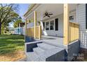 Inviting front porch with wooden railings and brick-painted stairs, perfect for relaxing outdoors at 112 Courtland St, Chester, SC 29706