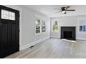 Bright living room features fresh paint, hardwood floors, a fireplace, and a decorative front door at 112 Courtland St, Chester, SC 29706