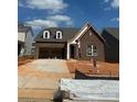 New construction home features a brick facade, attached garage, and a well-lit front entrance at 126 Goorawing Ln, Mooresville, NC 28115