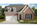 Charming brick and stone home featuring a two-car garage, dormer windows, and manicured landscaping at 126 Goorawing Ln, Mooresville, NC 28115