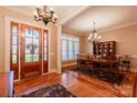 Formal dining room with hardwood floors, elegant lighting, and natural light at 152 Bay Shore Loop, Mooresville, NC 28117