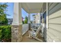 Inviting screened front porch features stone pillars and comfortable seating at 15237 Red Canoe Way, Charlotte, NC 28278