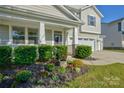 Beautifully landscaped front yard showcasing mature plantings and flowering accent plants at 15237 Red Canoe Way, Charlotte, NC 28278