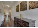 Entry hall featuring hardwood floors and decorative wall art at 15237 Red Canoe Way, Charlotte, NC 28278