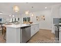 Bright kitchen featuring stainless steel dishwasher and white cabinets, open to the dining area at 159 Mooring Dr # 342Pp, Statesville, NC 28677