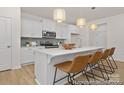 Modern kitchen with stainless steel appliances, a large island with seating, and stylish pendant lighting at 159 Mooring Dr # 342Pp, Statesville, NC 28677