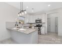 Modern kitchen featuring stainless steel appliances, granite countertops, and white cabinetry at 1612 Beleek Ridge Ln, Clover, SC 29710