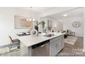 Open concept kitchen with stainless steel dishwasher and an eat-in island at 200 J.P. Dr # 184P, Albemarle, NC 28001