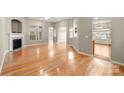 Open living area with hardwood floors, fireplace, and plenty of natural light at 2009 Whippoorwill Ln, Indian Trail, NC 28079