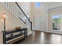 Bright foyer with high ceilings, hardwood floors, and an elegant staircase at 204 Silvercliff Dr, Mount Holly, NC 28120