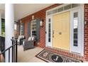 Inviting front porch featuring stylish seating and a bright yellow front door at 204 Silvercliff Dr, Mount Holly, NC 28120