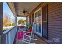 Charming front porch with rocking chairs and cozy seating with patterned cushions, overlooking the neighborhood at 210 Keltic Meadows Dr, Gastonia, NC 28056