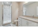Contemporary bathroom with marble shower, sleek vanity, and modern fixtures at 2123 Isom St, Charlotte, NC 28208