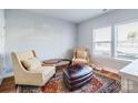 Cozy sitting area with natural light, two chairs, and a decorative rug at 2123 Isom St, Charlotte, NC 28208