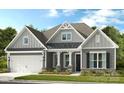 Charming gray home with a covered front porch, manicured lawn and neatly arranged landscaping at 2208 Indigo Branch Rd, Indian Land, SC 29707