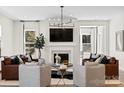 Cozy living room featuring a fireplace, large windows, and stylish furniture at 2208 Indigo Branch Rd, Indian Land, SC 29707