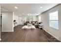 Bright and airy living room with hardwood floors and a cozy seating arrangement at 226 Malvern Sw Dr, Concord, NC 28025