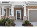 Inviting front porch with stone pillars and a 'welcome' sign, leading to the entrance of the house at 2352 Seagull Dr, Denver, NC 28037