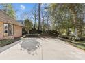 Wide driveway of a charming brick house with a side entry garage and mature trees at 2419 Lemon Tree Ln, Charlotte, NC 28211