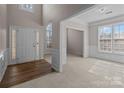 Open foyer area with hardwood floors, carpet, wainscoting, and natural light at 3203 Arklow Rd, Charlotte, NC 28269